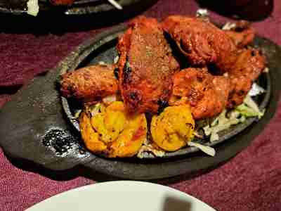 Tandoori Prawn and Tandoori Chicken served on a sizzling hot plate